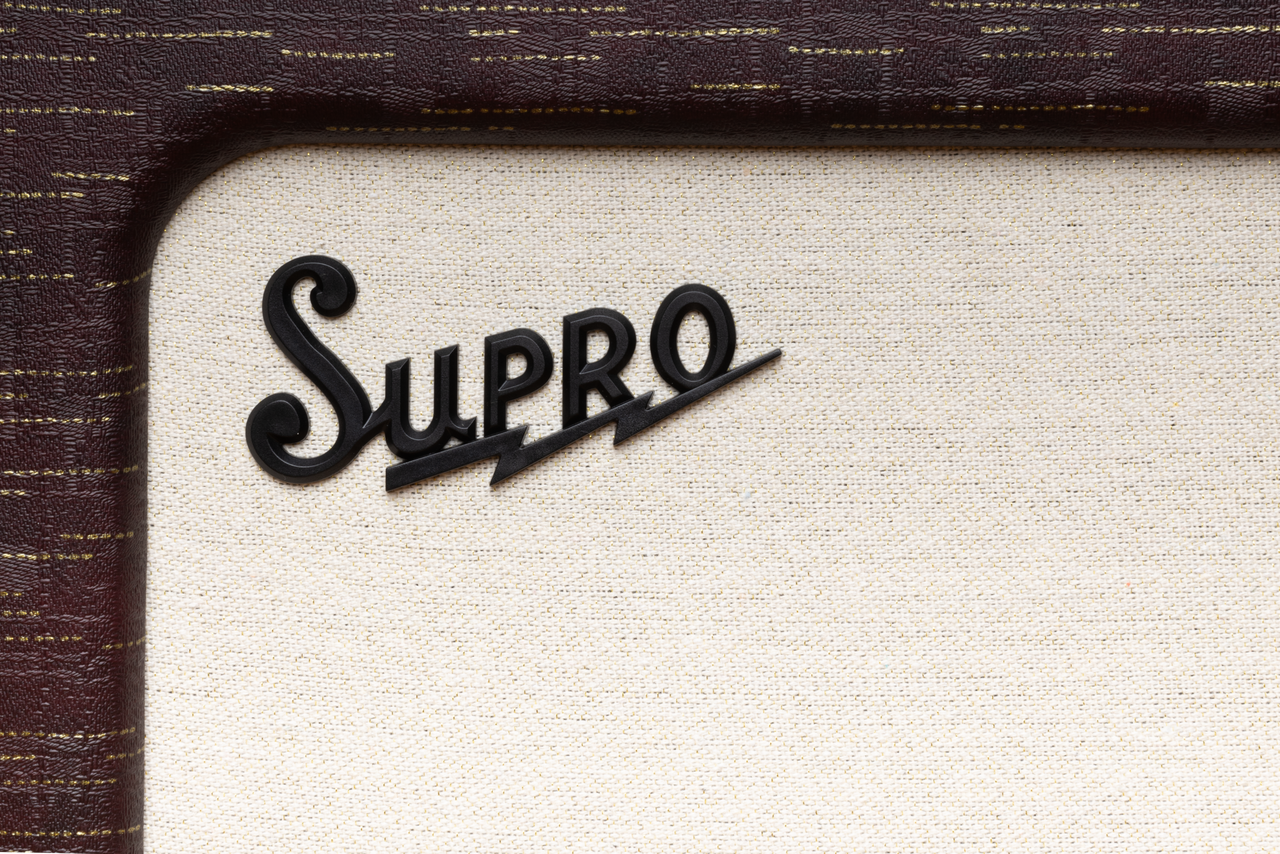 Supro Delegate 1x12 combo amplifier in Burgundy Gold Scandia featuring 25-watt tube power, built-in reverb, classic Supro circuitry, and expressive tonal character.