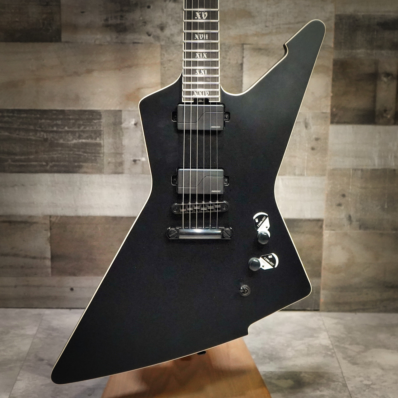 Schecter E-1 SLS Evil Twin electric guitar in Satin Black featuring an angular body design, ultra-thin neck profile, high-output humbuckers, premium SLS construction, and modern blacked-out hardware.