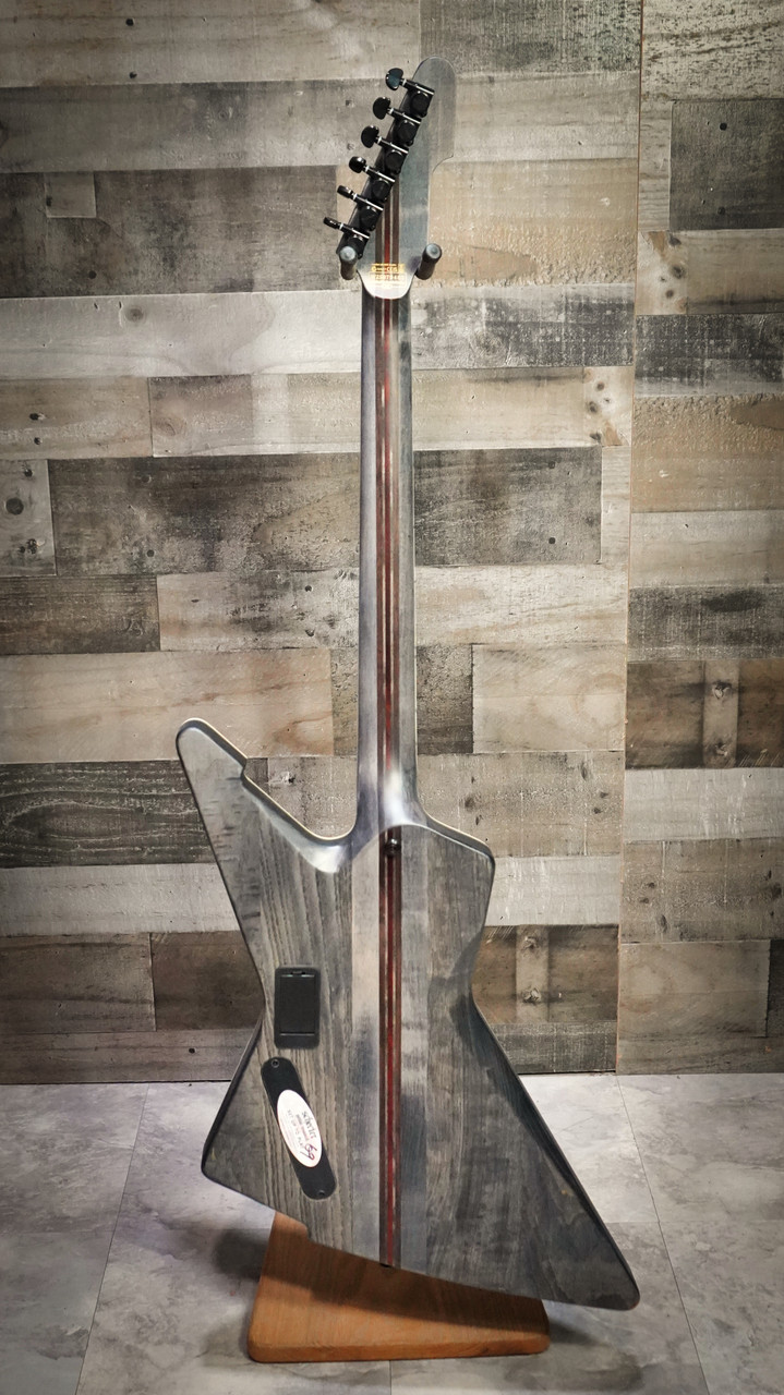 Schecter E-1 SLS Evil Twin electric guitar in Satin Black featuring an angular body design, ultra-thin neck profile, high-output humbuckers, premium SLS construction, and modern blacked-out hardware.