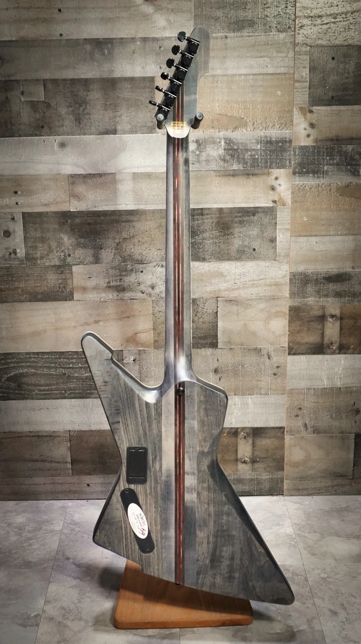 Schecter E-1 SLS Evil Twin electric guitar in Satin Black featuring an angular body design, ultra-thin neck profile, high-output humbuckers, premium SLS construction, and modern blacked-out hardware.