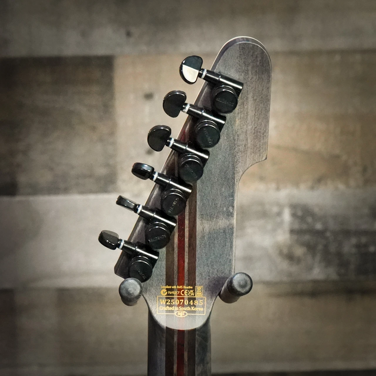 Schecter E-1 SLS Evil Twin electric guitar in Satin Black featuring an angular body design, ultra-thin neck profile, high-output humbuckers, premium SLS construction, and modern blacked-out hardware.