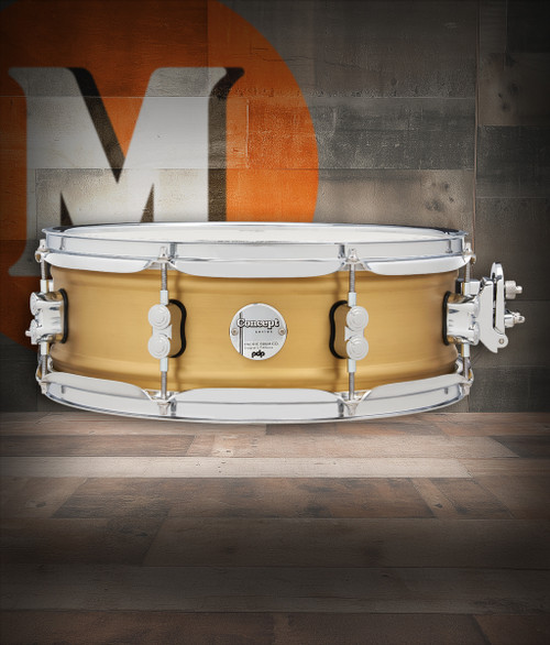 PDP Concept Series 5x14 Snare Drum in Natural Satin Brushed Brass with 1.2mm shell and chrome hardware, producing warm, punchy tone with elegant brushed finish.
