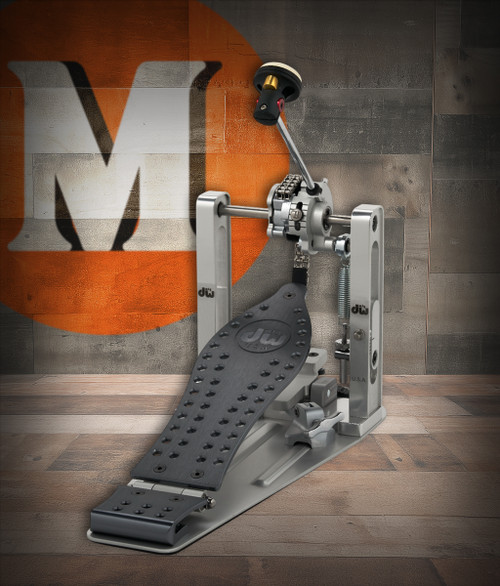 DW MFG Series Machined Chain Drive Single Pedal Gun Metal Edition with included carrying bag, showing dark gunmetal finish, precision-machined aluminum body, and smooth chain-drive mechanism.