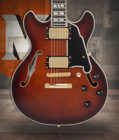 DÃ¢â‚¬â„¢Angelico Mini Double Cutaway electric guitar in Amaretto Burst featuring a carved double-cut body, stop-bar tailpiece, humbucking pickups, vintage-style hardware, and classic DÃ¢â‚¬â„¢Angelico craftsmanship.