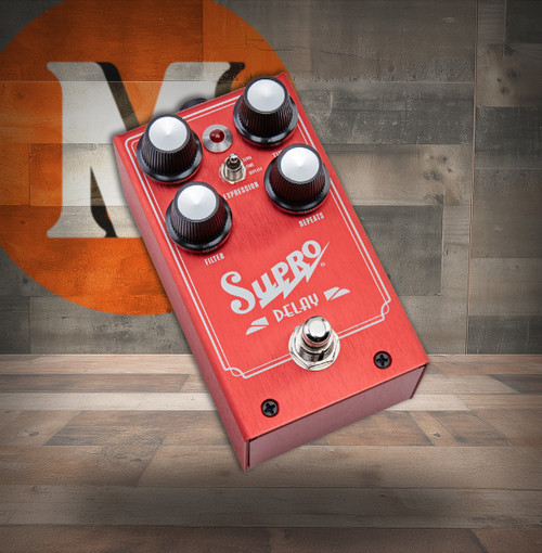 Supro 1313 Delay pedal featuring analog delay circuitry, warm tape-inspired repeats, time and feedback controls, and durable stompbox construction.