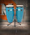 Toca Synergy Conga Set 10"/11" - Blue (2300BB) featuring blue-finished shells, durable hardware, warm resonant tone, and an included adjustable double conga stand.