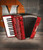 The Hohnica 12 Bass entry level piano accordion in pearl red (1303-RED) is perfect for beginners and students. Lightweight, easy to play, available at Musician Madness.