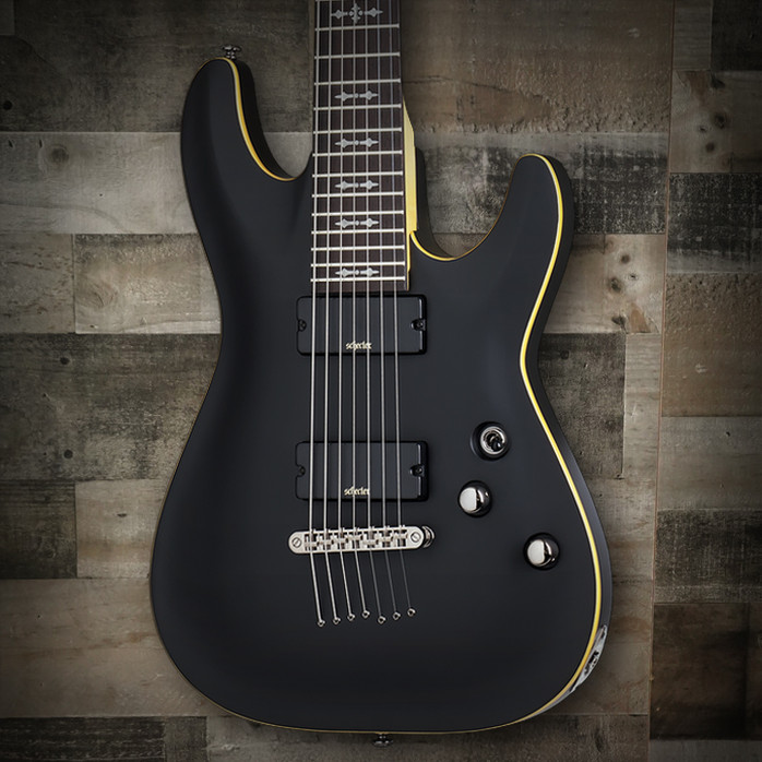 Schecter Demon-7 Electric Guitar – Aged Black Satin finish featuring 7-string configuration, Schecter Diamond Active pickups, arched top body, and smooth fast neck for powerful modern metal tone