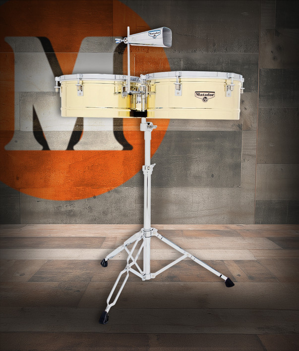 Latin Percussion M257B Matador 14"/15" Brass Timbales featuring polished brass shells, chrome hardware, bright cutting tone, and an included cowbell—ideal for salsa, timba, and Latin jazz performance.