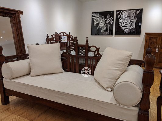 Shimoni wooden daybed with swahili designed carved backrest, and off-white upholstered cushions
