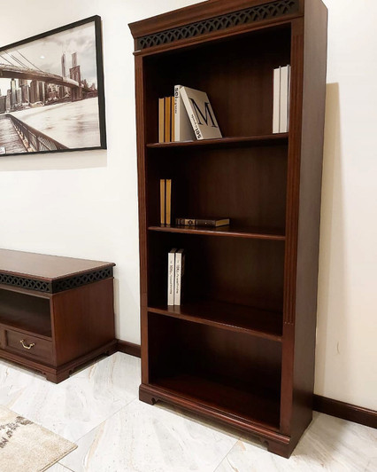 Four tier wooden bookcase with open shelving.