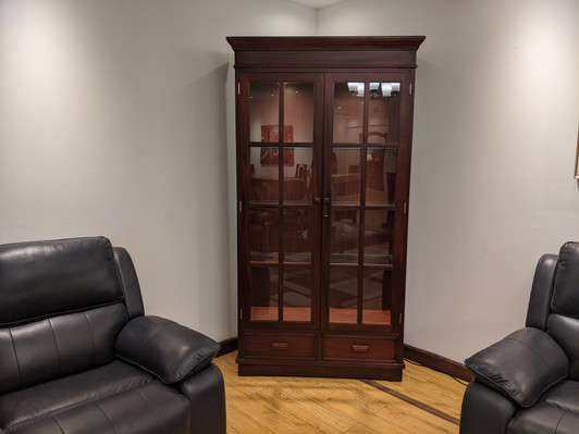 Glass door display cabinet with wood frame and internal shelving.