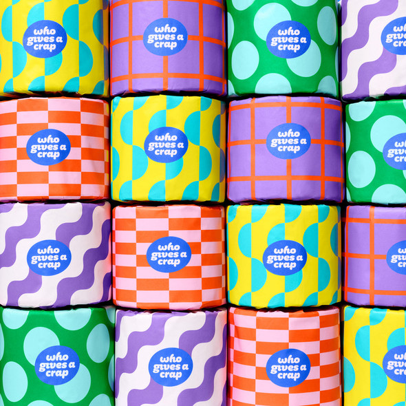 Close-up of colourful Who Gives A Crap toilet paper rolls stacked in a grid pattern