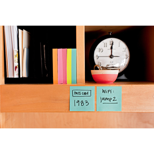 Post-it Super Sticky Notes Miami Collection used for reminders on a wooden shelf with books and clock.
