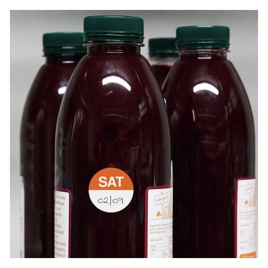 Avery Saturday food rotation label on a bottled drink showing handwritten date marking for stock control and freshness.
