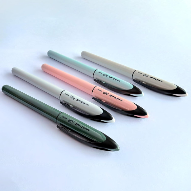 Set of five Uni-ball Air Micro pastel barrel pens in assorted colours arranged on white surface Set of five Uni-ball Air Micro pastel barrel pens in assorted colours arranged on white surface