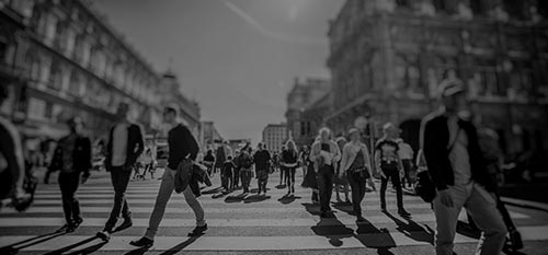 People walking through busy intersection