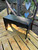 Black wood bench showing solid wood top and legs