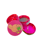 Glittery pink 4-piece grinder featuring an illustrated fluffy cat with a green bow, shown open with grind chamber, screen, and kief tray exposed.