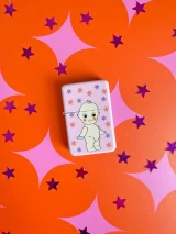 Closed pink Lobotobaby metal lighter featuring a cartoon Kewpie baby surrounded by colorful stars.