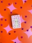 Closed pink Lobotobaby metal lighter featuring a cartoon Kewpie baby surrounded by colorful stars.