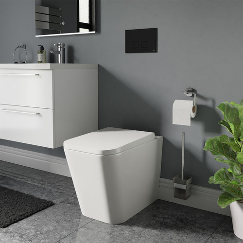 A modern back to wall toilet including concealed cistern and flush plate