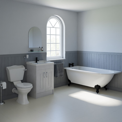 A traditional bathroom suite including left hand freestanding shower bath, vanity unit and close coupled toilet