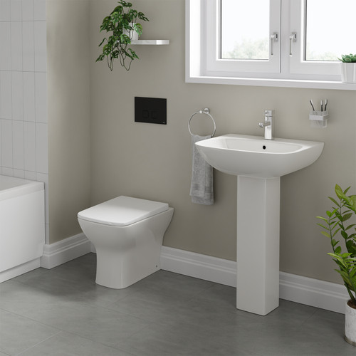 A modern basin and pedestal with back to wall toilet including concealed cistern and flush plate