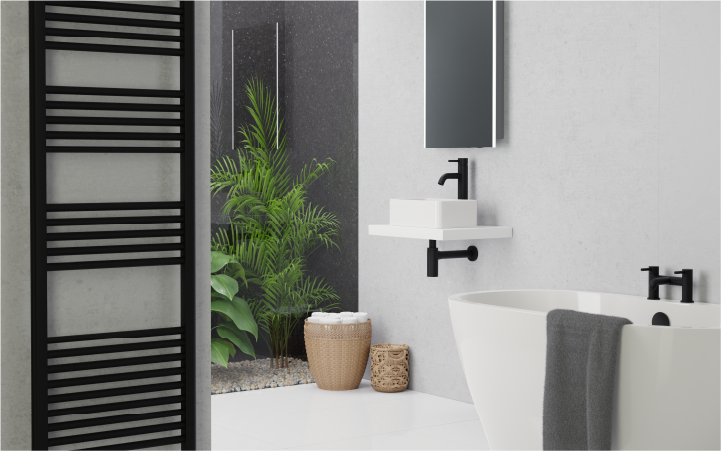 Black towel rail in bathroom with bath and greenery