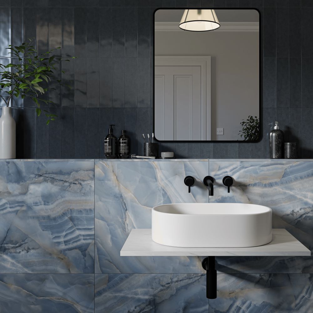 Tiled bathroom with blue marble effect tiles and dark blue metro tiles