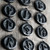 Rune pendant worn as a necklace – shungite amulet hanging on a black adjustable cord, resting on a person’s chest. The 36mm stone complements any outfit, suitable for men and women. Natural stone with subtle shine.