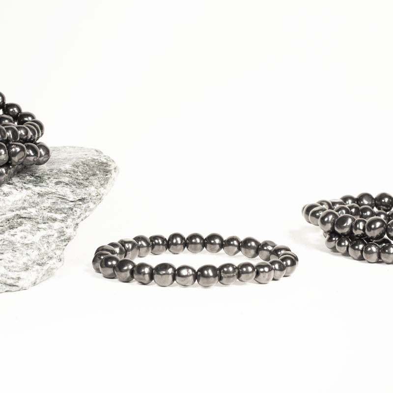 Pure Type II Shungite bracelet from Russia. Loose bead design for max energy flow. Grounding, EMF protection, stress relief. Fits 6.5"-7.3" wrists. Includes authenticity certificate.