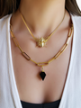 Woman Wearing Two Styled Necklaces. Top Necklace is Gold Herringbone Snake Chain with Large Gold Bee Necklace Connector. Bottom Necklace is Gold Chunky Link Chain with Diamond Shape Black and Gold Crystal Necklace Pendant. | Mojo Supply Co