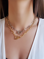 Woman Wearing 2 Haven Oval Link Chain Toggle Clasp Necklaces In Gold And Silver