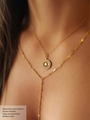 Woman with Brown Hair Wearing Two Gold Necklaces. Top Necklace is a Dainty Gold Chain with Round Gold and CZ Stone Large Paige Pendant. Bottom Necklace is Custom Made Gold Sequin Disc Chain in Y Design | Mojo Supply Co