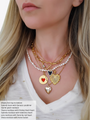 Woman Wearing Layered Heart Charm Necklaces With Classic Pearl Necklace