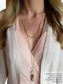 Woman Wearing Gold Sunburst Chain Layered With Long Rosary Necklace With Pink Tassel Pendant