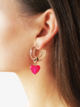Woman Wearing Clear Chunky Hoops With Pink Puffy Heart Charms