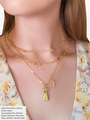 Woman Wearing A Paper Clip Chain Choker And Three Gold Necklaces Layered With Rectangle Bitch Pendant And A Body Figure Charm | Mojo Supply Co