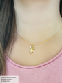Woman Wearing A Gold Filled Necklace Layered With A Gold Teddy Bear Jeweled Necklace Pendant | Mojo Supply Co