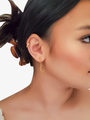 Woman Wearing A Gold Hoop Earring With A Gold Crescent Moon Charm | Mojo Supply Co