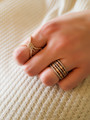 Woman Wearing Ellianna Rose Gold Statement Knot Ring And Vienna Gold And Silver Stacker Rings | Mojo Supply Co