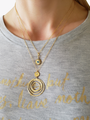 Woman Wearing Sloane Necklaces With Willow Matte Gold Turquoise Evil Eye Pendant, Bibi Celestial Connector And Marissa Multiple Gold Circles Pendant | Mojo Supply Co
