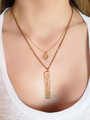 Woman wearing two elegant gold necklaces.  Top necklace is dainty with small round CZ opal pendant. Lower necklace is thicker cable with bar matte gold bar pendant | Mojo Supply Co