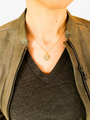 Woman wearing sleek gold necklace styled with Kate gold celestial necklace pendant | Mojo Supply Co