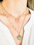Woman Wearing Kelsey Gold Filled Box Chain Necklace With Jin Cubic Zirconia Celestial Pendant Layered With Kaiya Long Beaded Rosary Chain With Green Fluorite Amiya Pendant