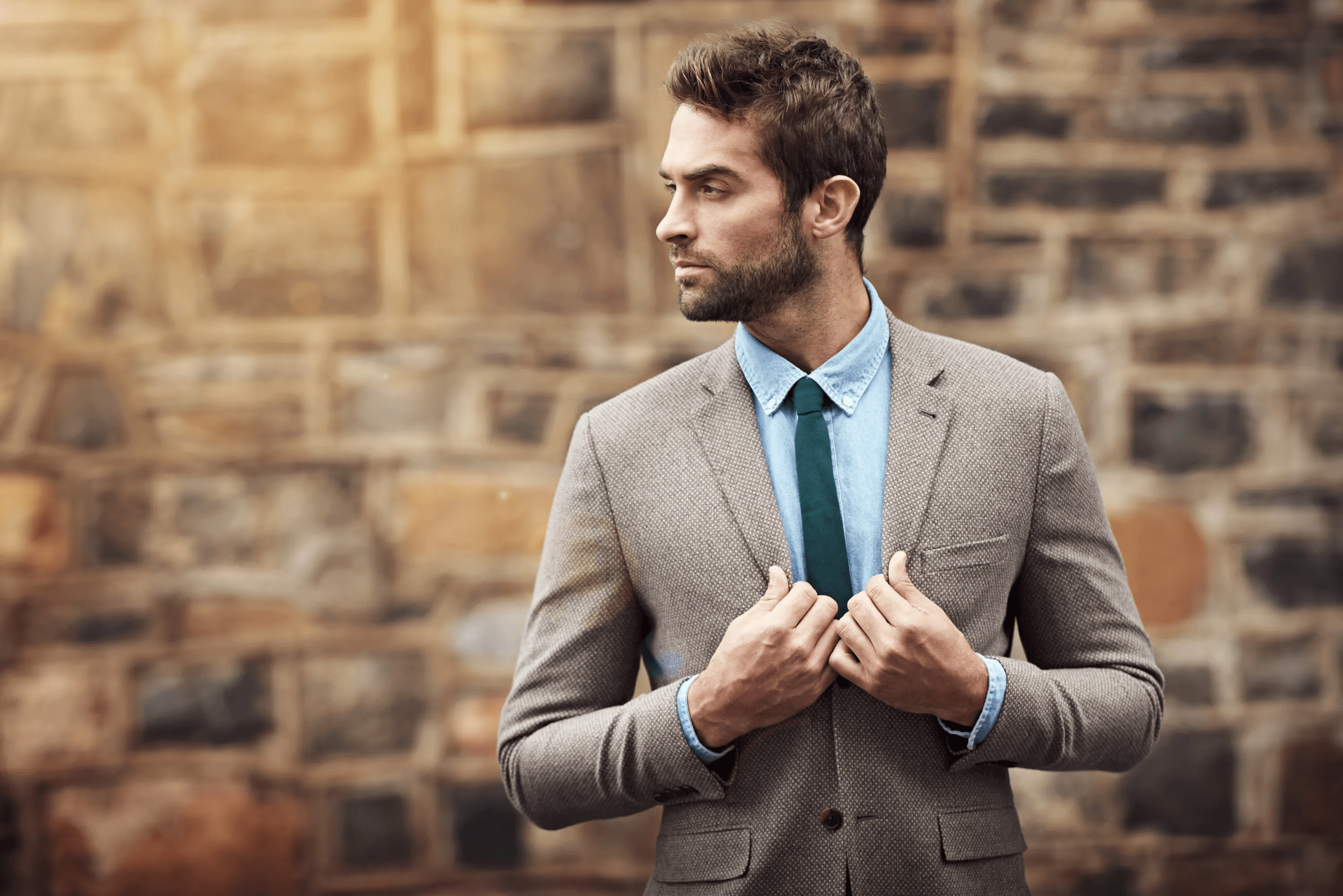 Stylish man in suit posing on chair Stock Photo by ©IgorVetushko 171481708