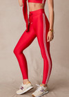 THE UPSIDE women's red eco tech Oxford 25-inch Legging is supportive and comfortable with cream side stripes and an elastic waist drawcord. Made for high impact.