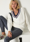 THE UPSIDE women’s cream organic cotton Espada Louie V Neck Sweater is a regular, chunky cable knit design with a navy and rose striped neckline. Made for everyday.