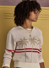 THE UPSIDE women's creme organic cotton Palma Joni Knit Crew features raglan sleeves, palm tree chest design, and red stripes around back and sleeves. Made for lifestyle.